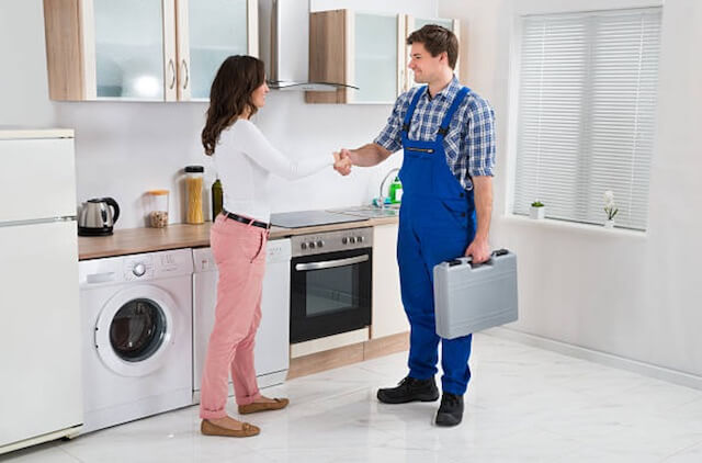 appliance repairman with customer in green bay