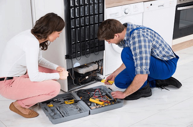 repairman fixing refrigerator in green bay